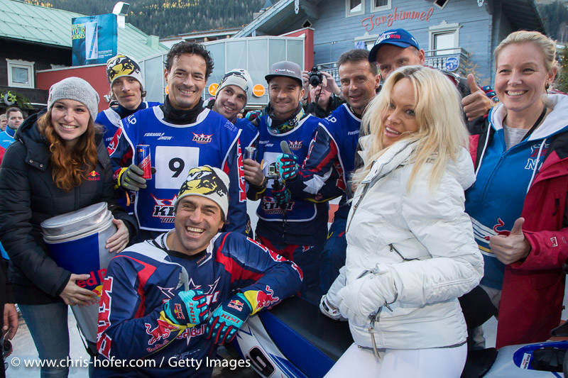 SAALBACH-HINTERGLEMM, AUSTRIA - DECEMBER 05:   Pamela Anderson poses with KINI Red Bull team members Kristian Ghedina, Kris Rosenberger, Simo Kirssi, Ben Hemingway, Timo Scheider, Andy Meklau and Heinz Kinigadner during the third and final day of the Formula Snow 2015 ski opening on December 5, 2015 in Saalbach-Hinterglemm, Austria.  (Photo by Chris Hofer/Getty Images)
